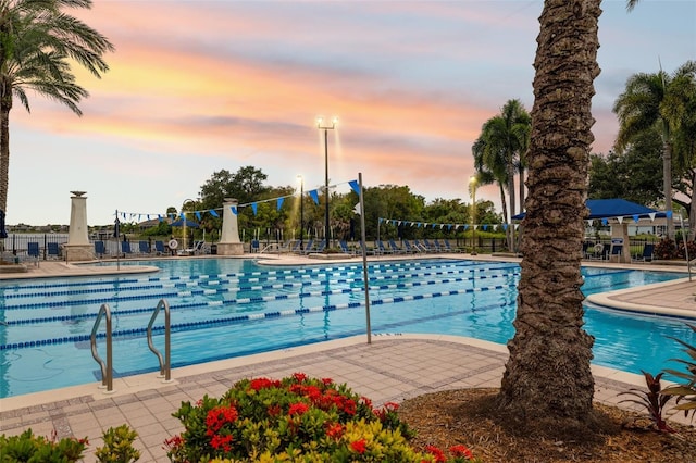 view of pool at dusk