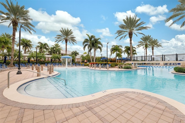 view of pool with a patio and pool water feature