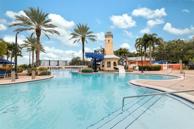 view of pool featuring a patio and a water slide