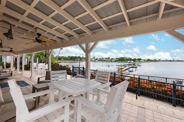 view of patio with a water view and ceiling fan