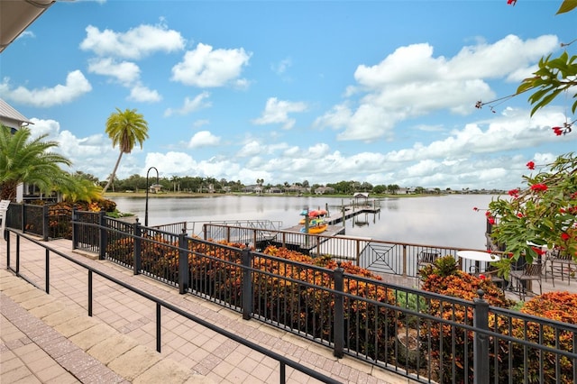 view of patio featuring a water view and a boat dock