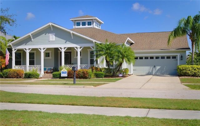 view of front of home featuring covered porch and a garage