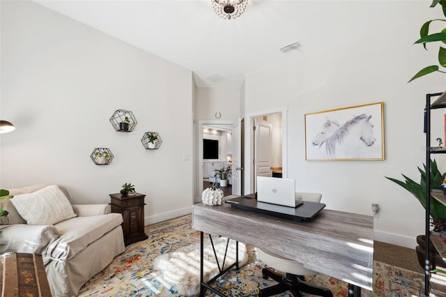 office area with visible vents and baseboards