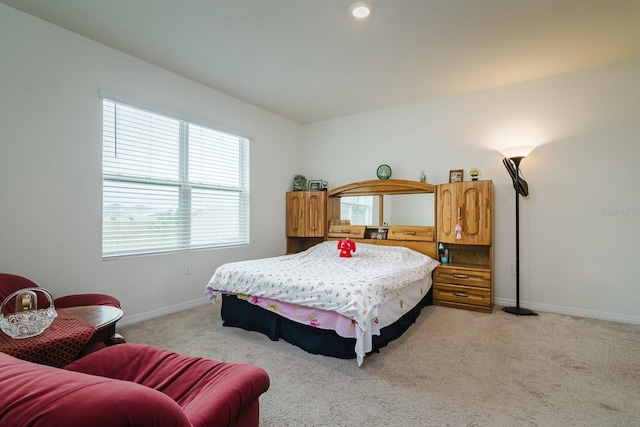 bedroom featuring light colored carpet