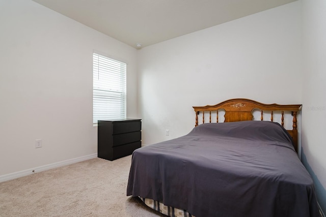 bedroom featuring light colored carpet