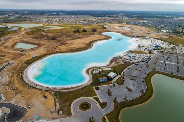 aerial view with a water view and a view of the beach