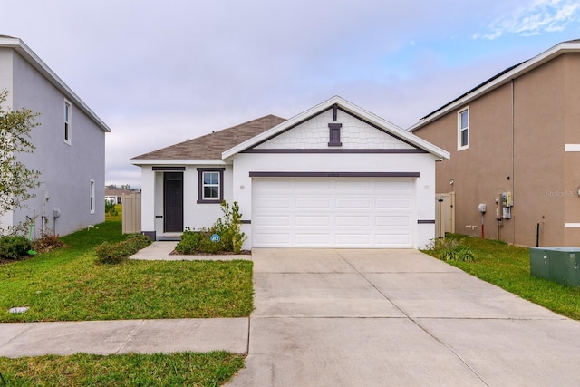 view of front of property with a garage and a front lawn