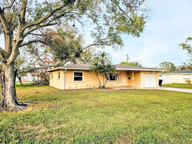 single story home with a front yard and a garage