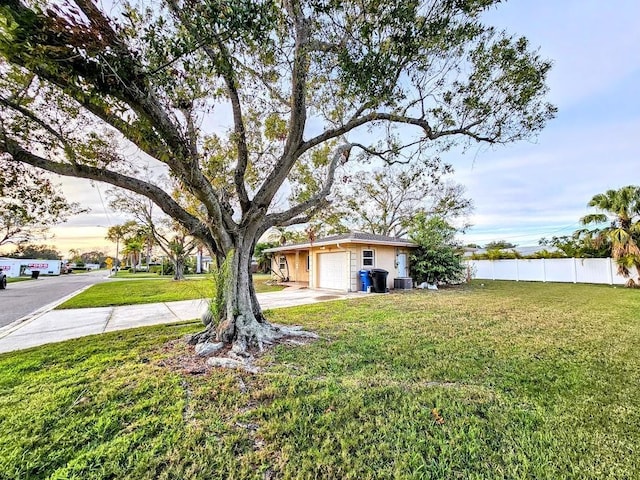 view of yard featuring central AC and a garage