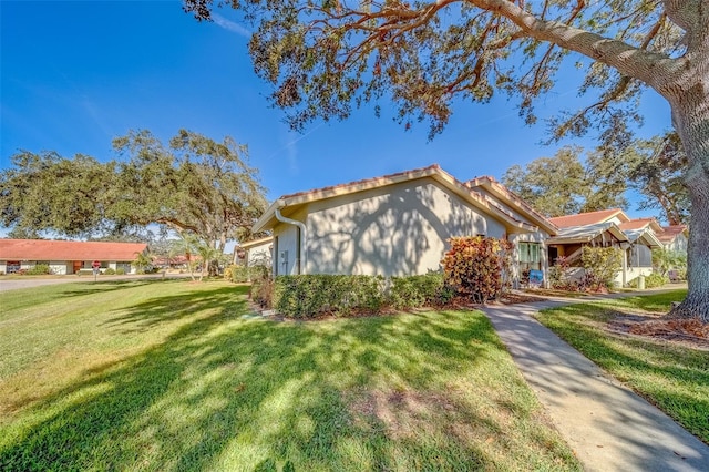 view of property exterior with a yard