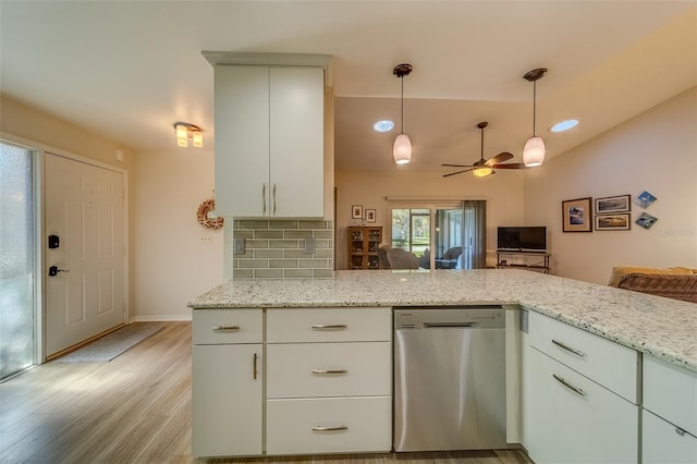 kitchen featuring kitchen peninsula, backsplash, stainless steel dishwasher, light stone counters, and ceiling fan