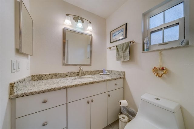 bathroom featuring vanity and toilet