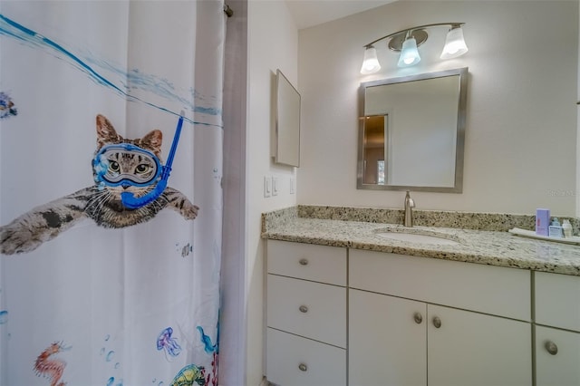 bathroom featuring a shower with curtain and vanity