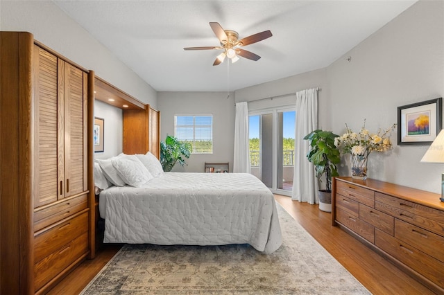 bedroom featuring access to exterior, ceiling fan, and wood-type flooring