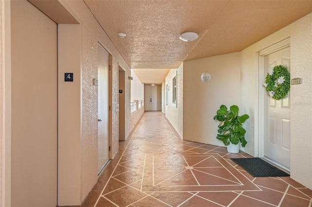 hallway with tile patterned floors and elevator