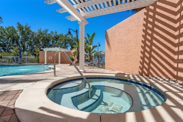 view of swimming pool featuring a pergola, an in ground hot tub, and a patio