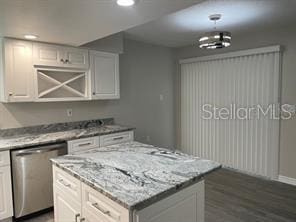 kitchen featuring dishwasher, white cabinetry, and light stone countertops