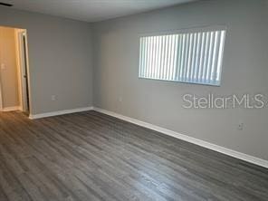 empty room with dark hardwood / wood-style floors