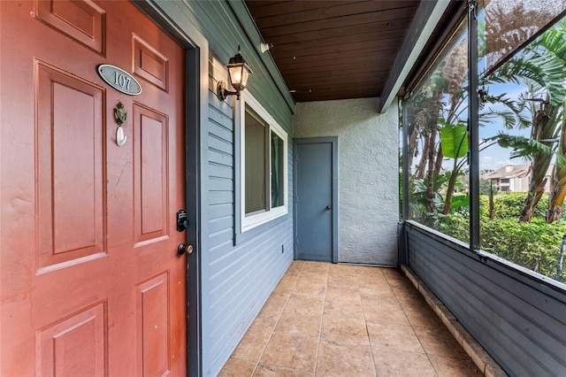 unfurnished sunroom featuring wood ceiling