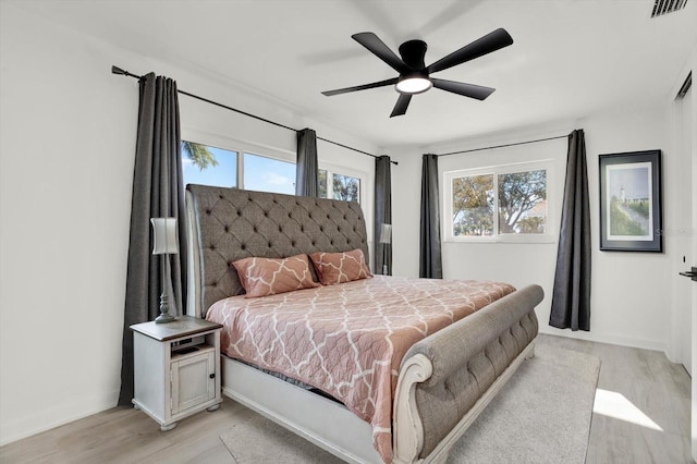 bedroom with ceiling fan and light hardwood / wood-style flooring