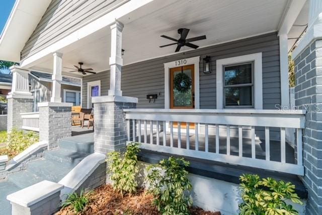 property entrance with a porch and ceiling fan