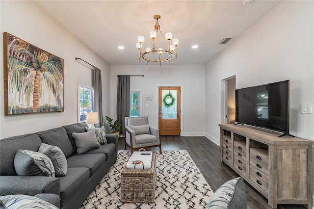 living room featuring dark hardwood / wood-style flooring and a chandelier