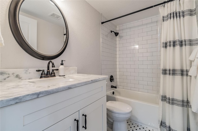 full bathroom with vanity, shower / tub combo, and toilet