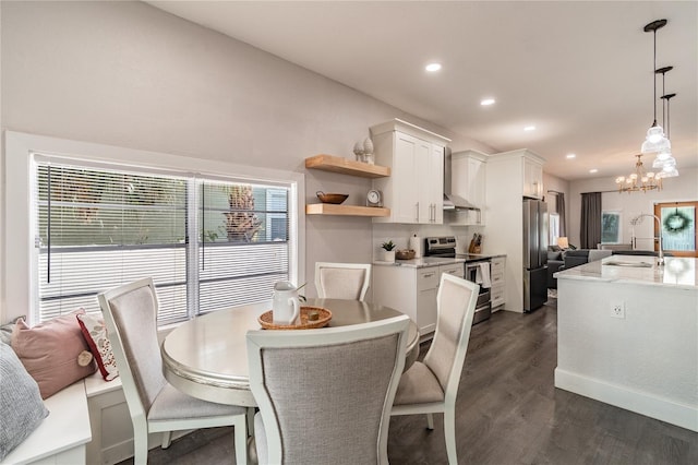 dining room featuring dark hardwood / wood-style flooring, an inviting chandelier, and sink