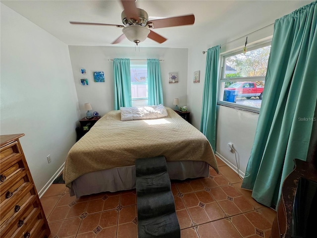 tiled bedroom featuring ceiling fan