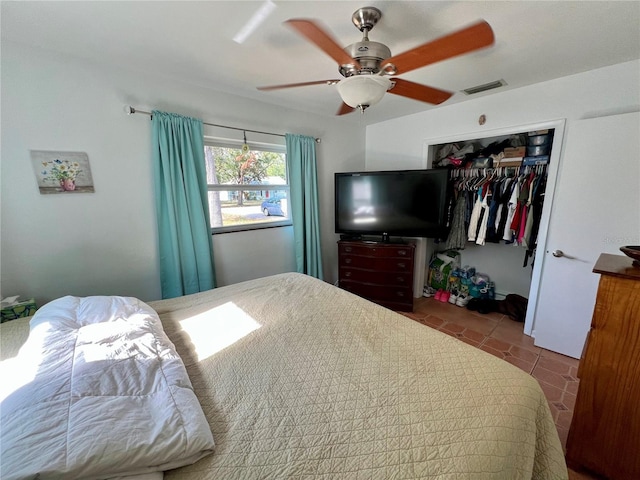 bedroom with ceiling fan, a closet, and tile patterned floors