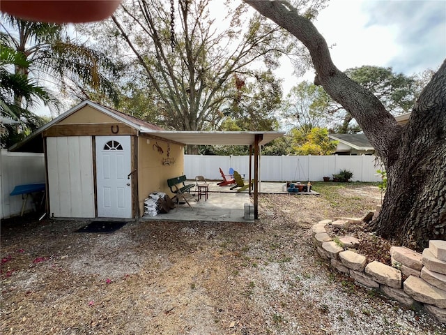 view of yard with a shed and a patio