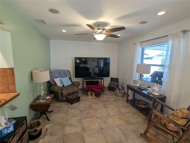 tiled living room featuring ceiling fan