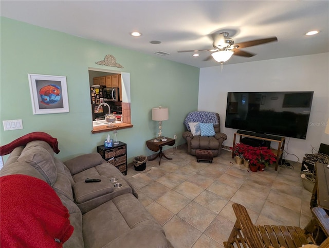 tiled living room with ceiling fan