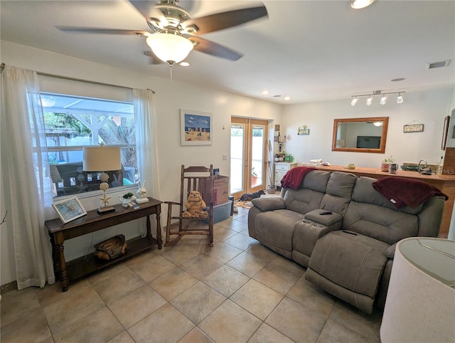 living room featuring ceiling fan, rail lighting, light tile patterned floors, and french doors