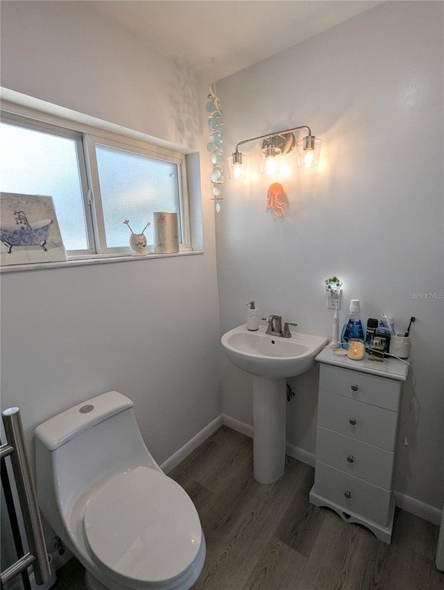 bathroom with toilet and wood-type flooring