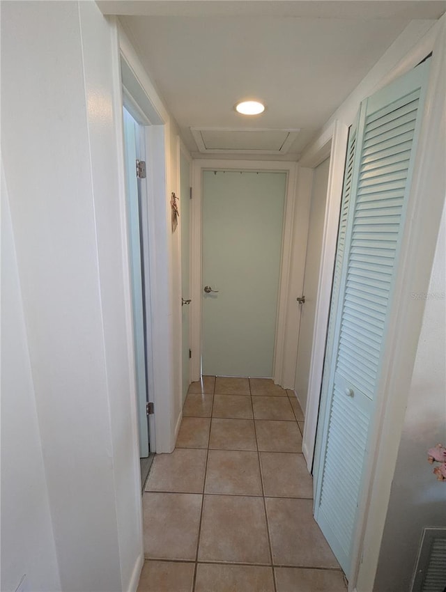 corridor featuring light tile patterned floors