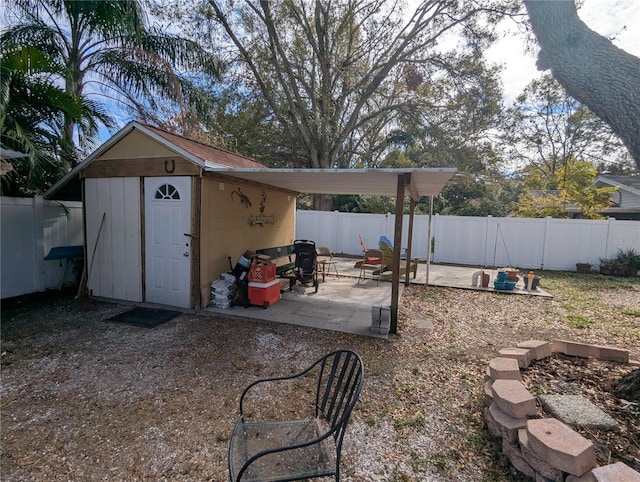 view of yard featuring a shed and a patio