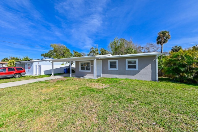 ranch-style home with a front yard and a carport