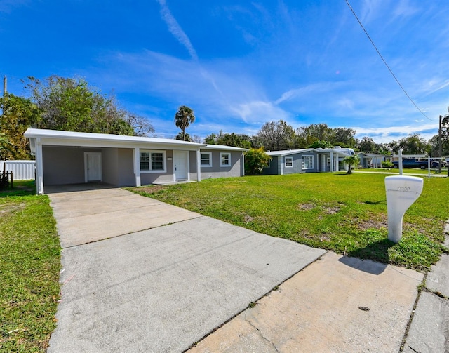 single story home with a front yard and a carport