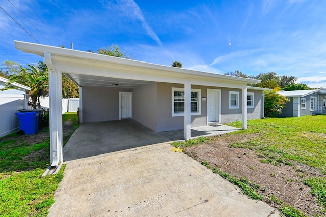 ranch-style home with a front yard and a carport