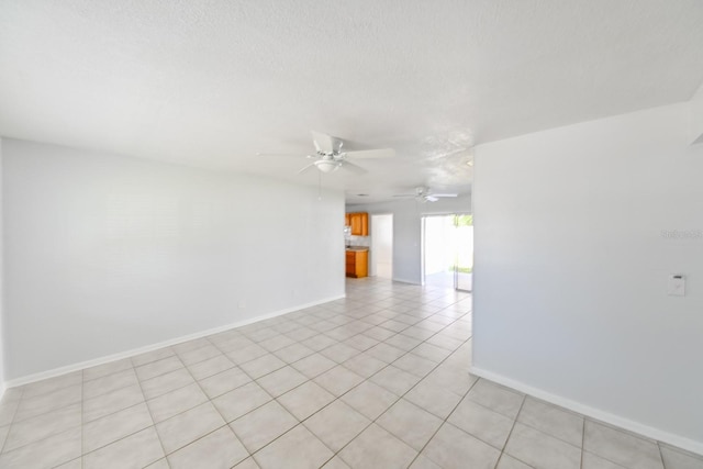 unfurnished room featuring ceiling fan, a textured ceiling, and light tile patterned flooring