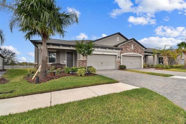 view of front of house featuring a garage and a front lawn