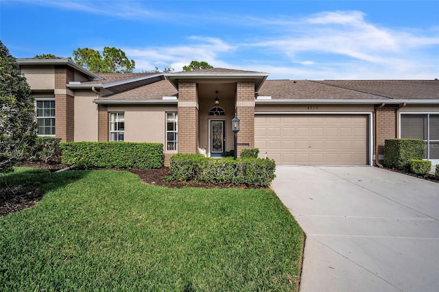 view of front of home featuring a garage and a front lawn