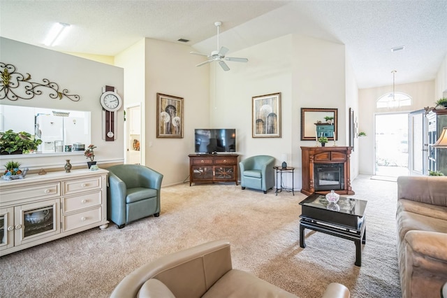 living room with ceiling fan, high vaulted ceiling, light colored carpet, and a textured ceiling