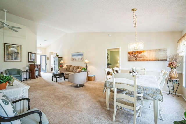 dining area with light carpet, a textured ceiling, ceiling fan with notable chandelier, and vaulted ceiling