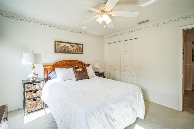 carpeted bedroom featuring a closet and ceiling fan