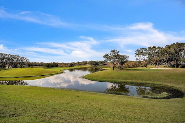 surrounding community with a yard and a water view