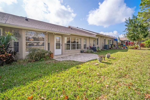 back of property featuring a lawn, a patio, and central AC unit