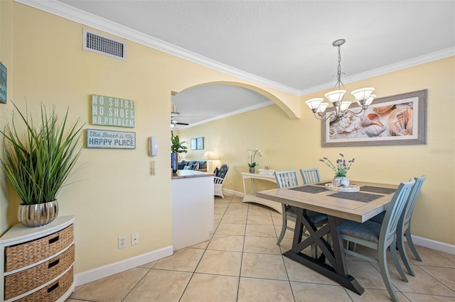 tiled dining room featuring ceiling fan with notable chandelier and ornamental molding