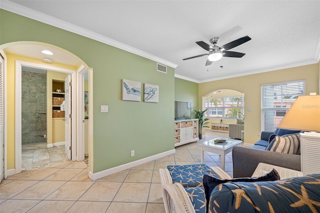 living room with light tile patterned floors, ceiling fan, and ornamental molding